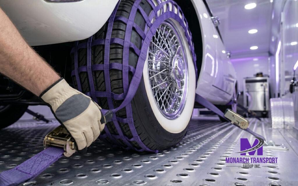 Securely securing a classic car wheel using a soft nylon strap (wheel net) inside the trailer.
