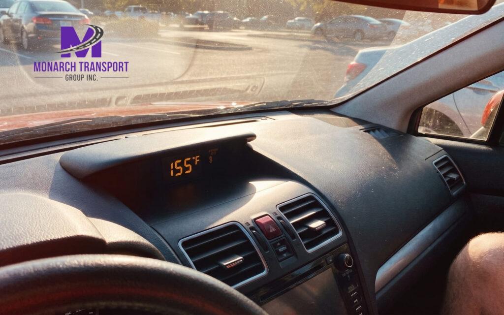 Close-up of a car dashboard showing extreme high temperature inside a vehicle during summer.