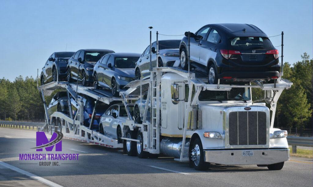 Monarch - How Dealerships Ship Cars from Auto Auctions_ Costs, Timeline, and What to Expect 4 Open auto transport trailer carrying dealership inventory from auction.